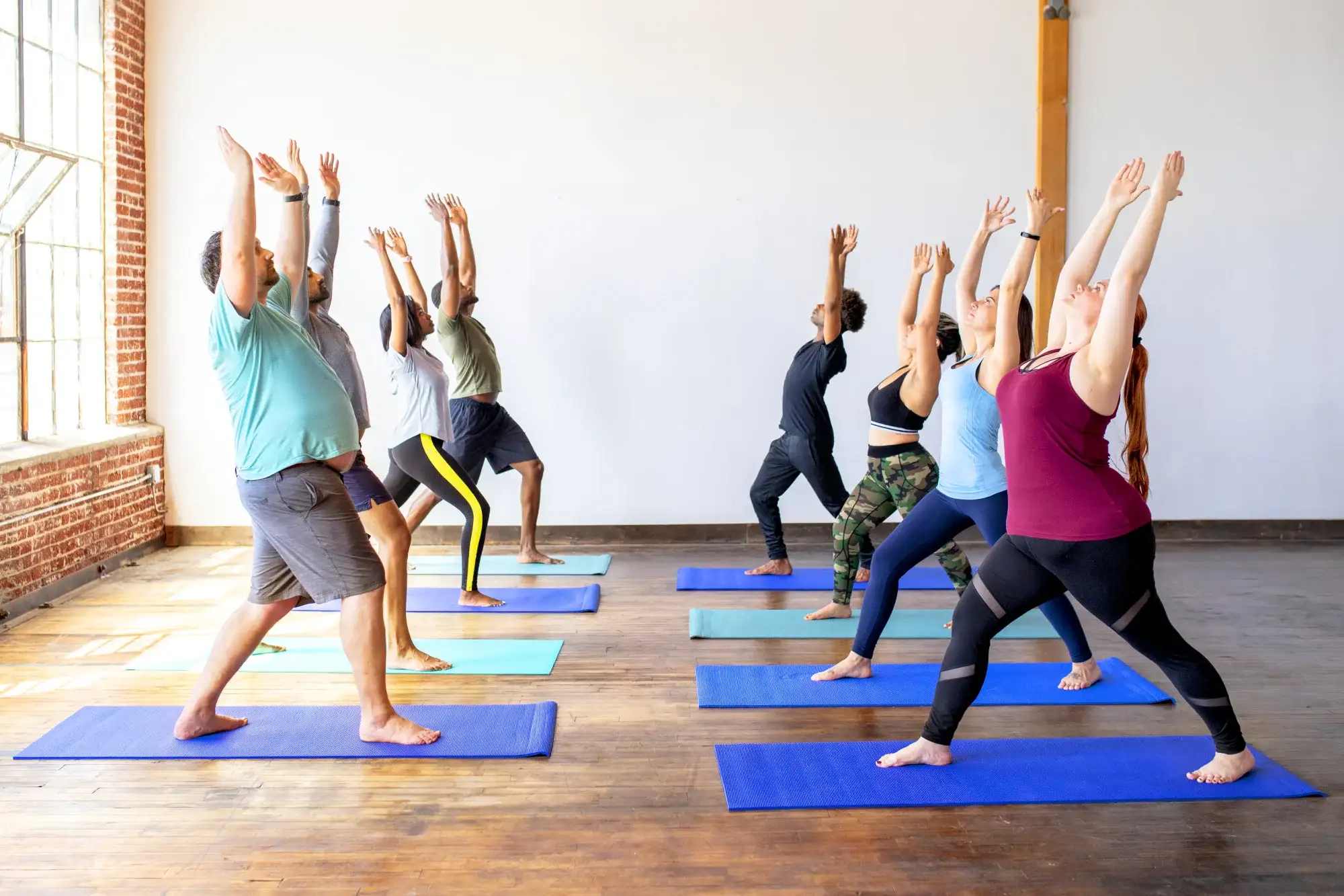 A group holding warrior pose at a private event
